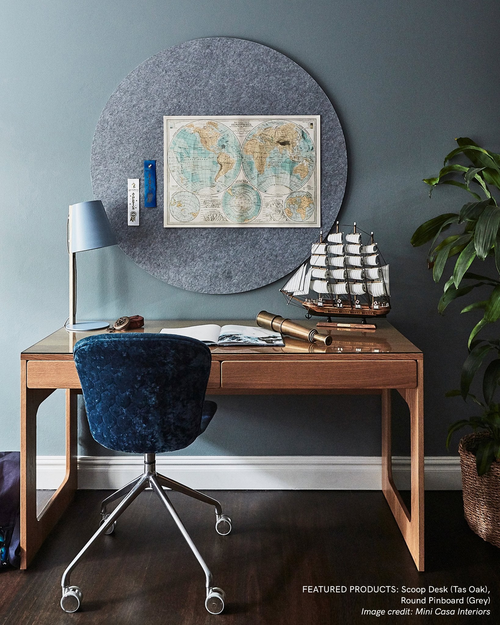 Circular Bulletin board in grey mounted above a desk to help you to achieve a work/life balance.