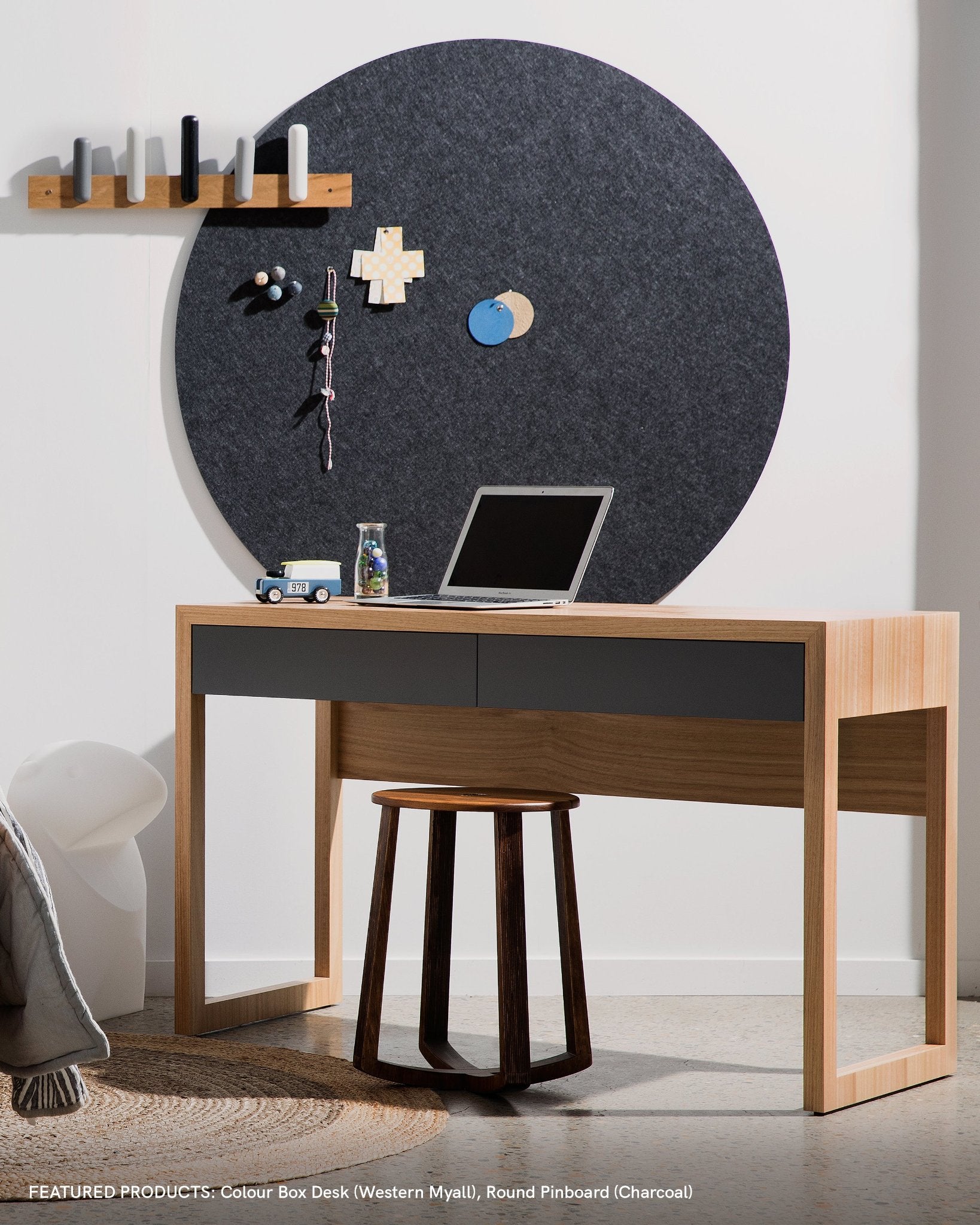 A large grey round pin board in a kids study desk setting, used to pin up reminders, notes and ideas