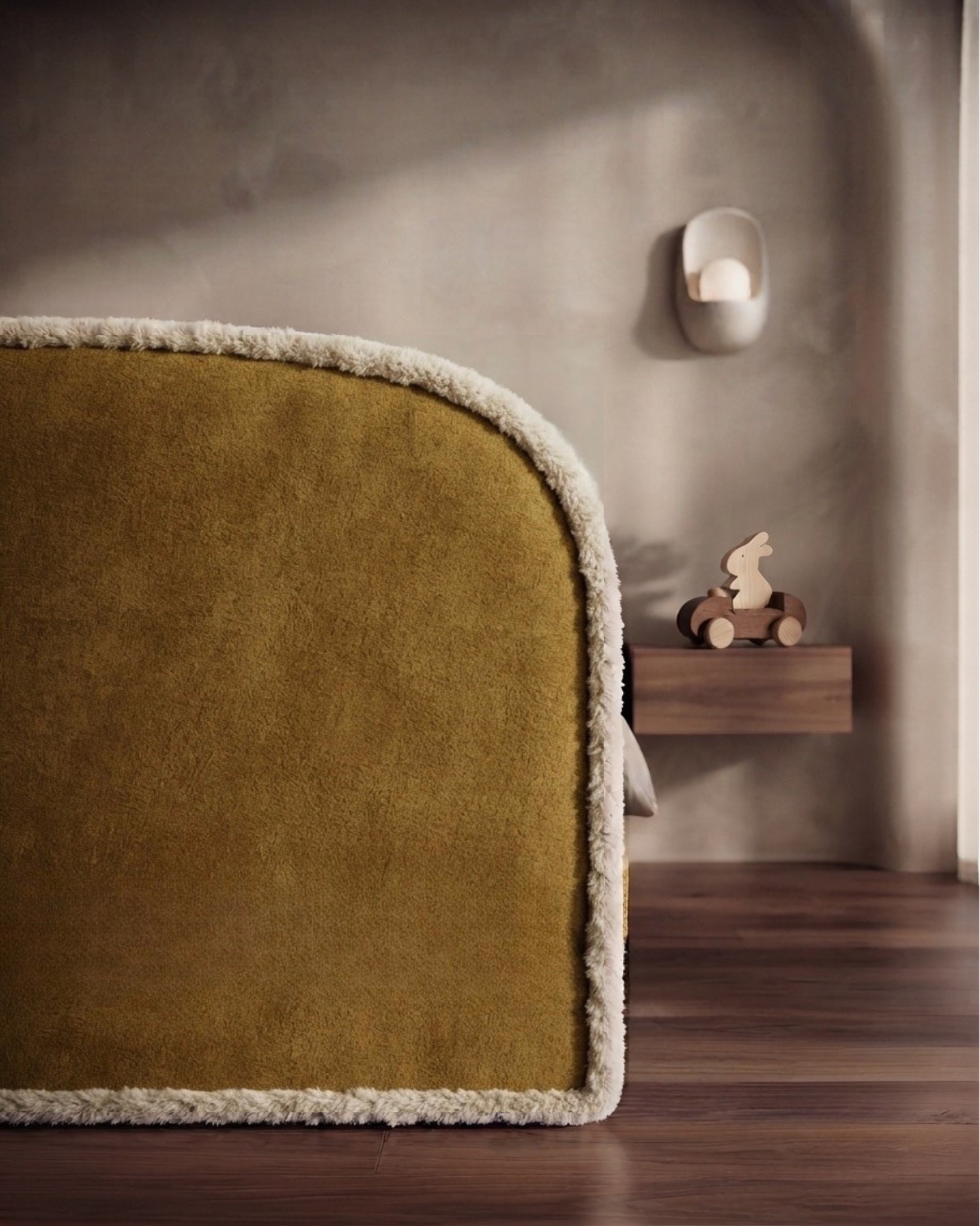 A close-up of a mustard yellow bed with center cream-colored fluffy border. thie sbed was customised by Lilly & Lolly children's furniture company.