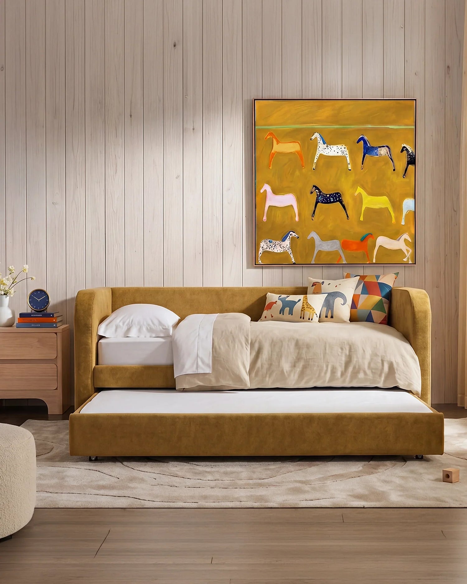 Mustard coloured sofa bed with pull out trundle for sleepovers.