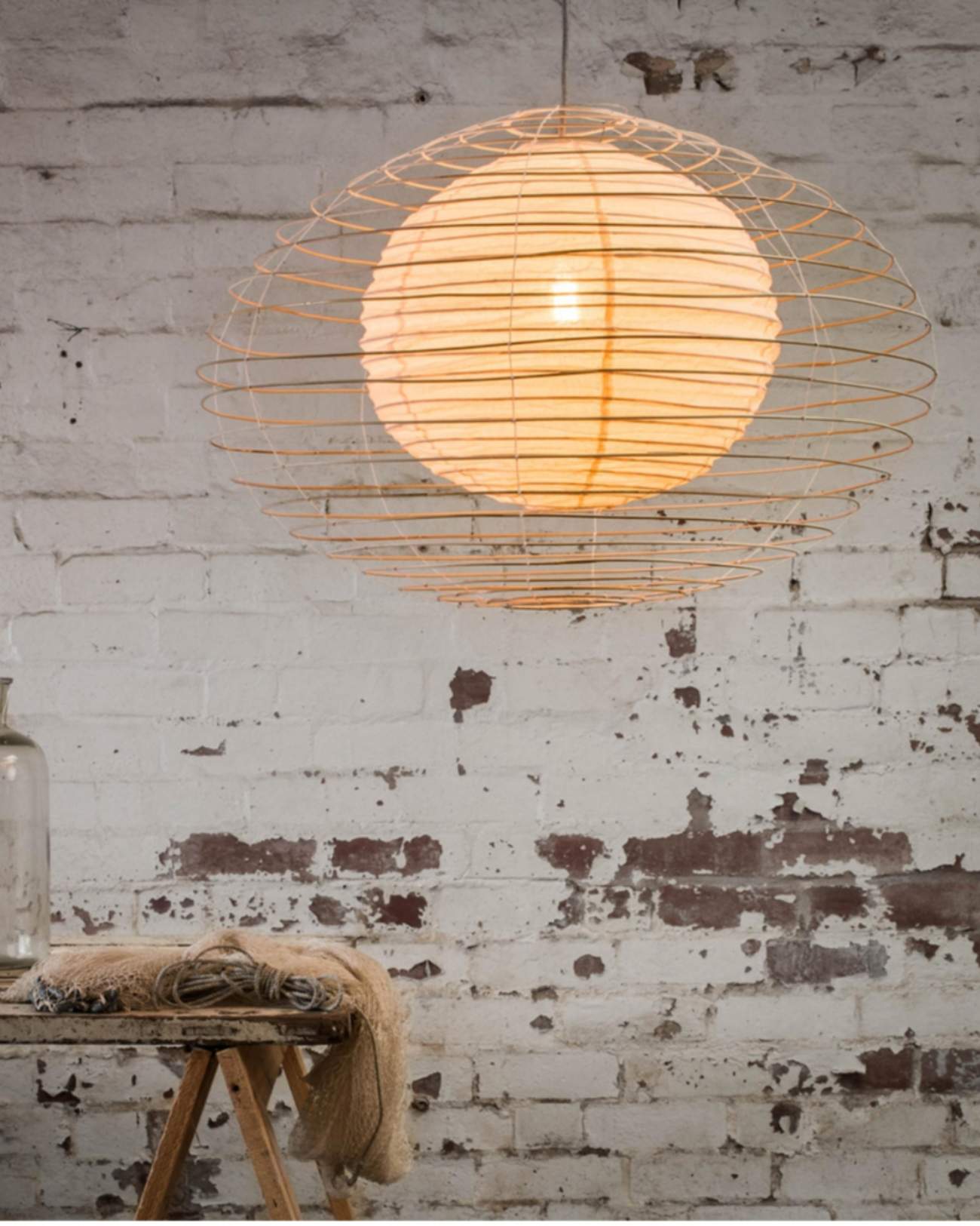 Create a cosy atmosphere for kids bedrooms with this creative pendant light. Designed by Sibella Court, the internal fabric lantern, shaped like the moon is encased in a fine bamboo eliptical shell. The orb lets off a warm glow when lit. This lantern does not include cord.