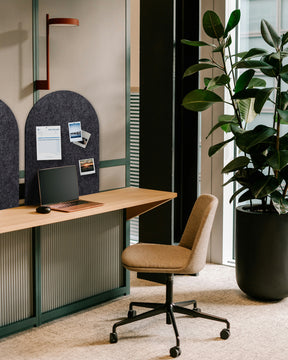 Arch Bulletin Board mounted in an office, providing a stylish and functional way to display notes and schedules.