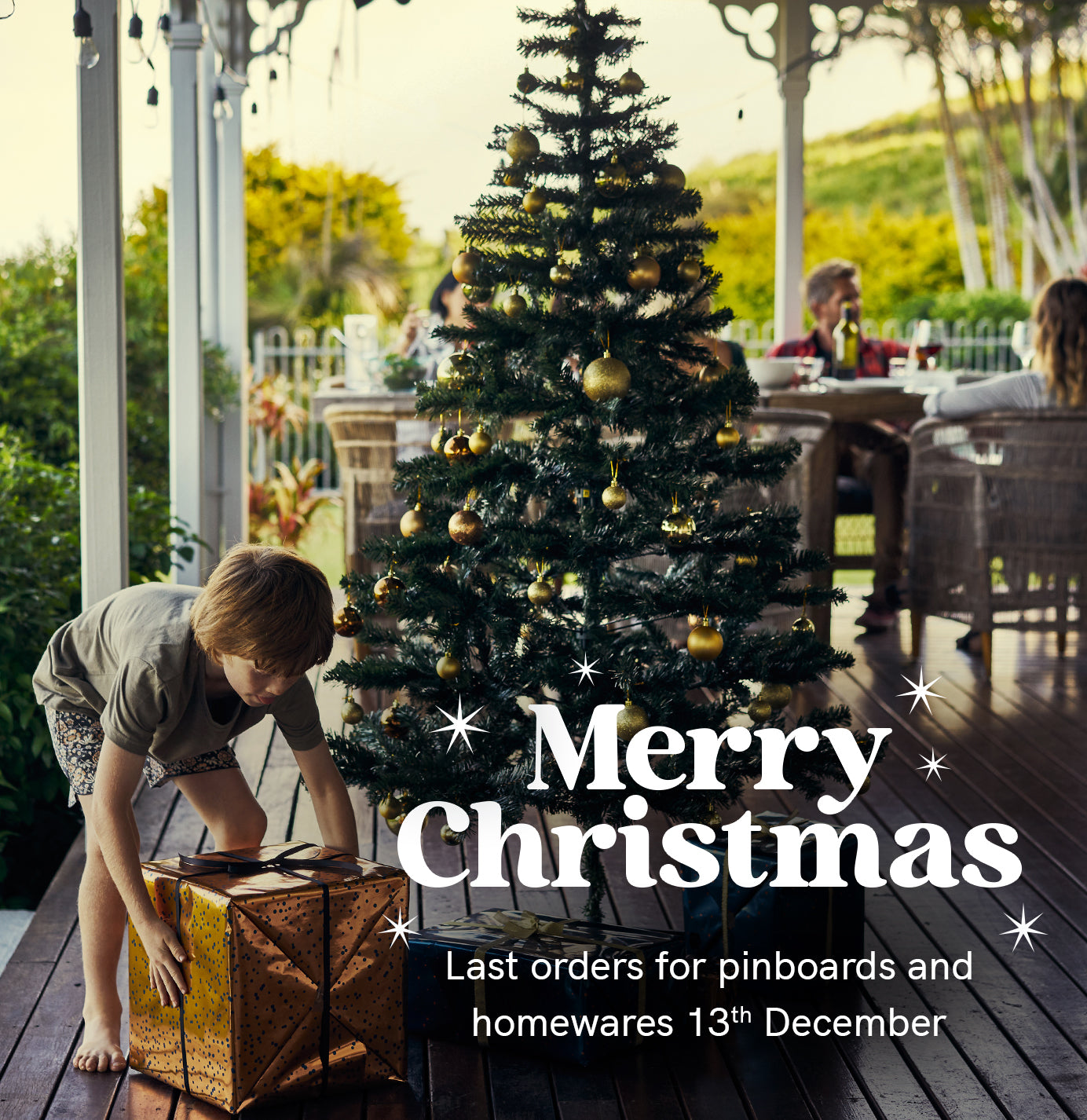 Lilly & Lolly offer high-end  kid's furntiure and pinboards for architects and designers and design lovers. Image is of a child fetching a gift from under the Christmas tree.