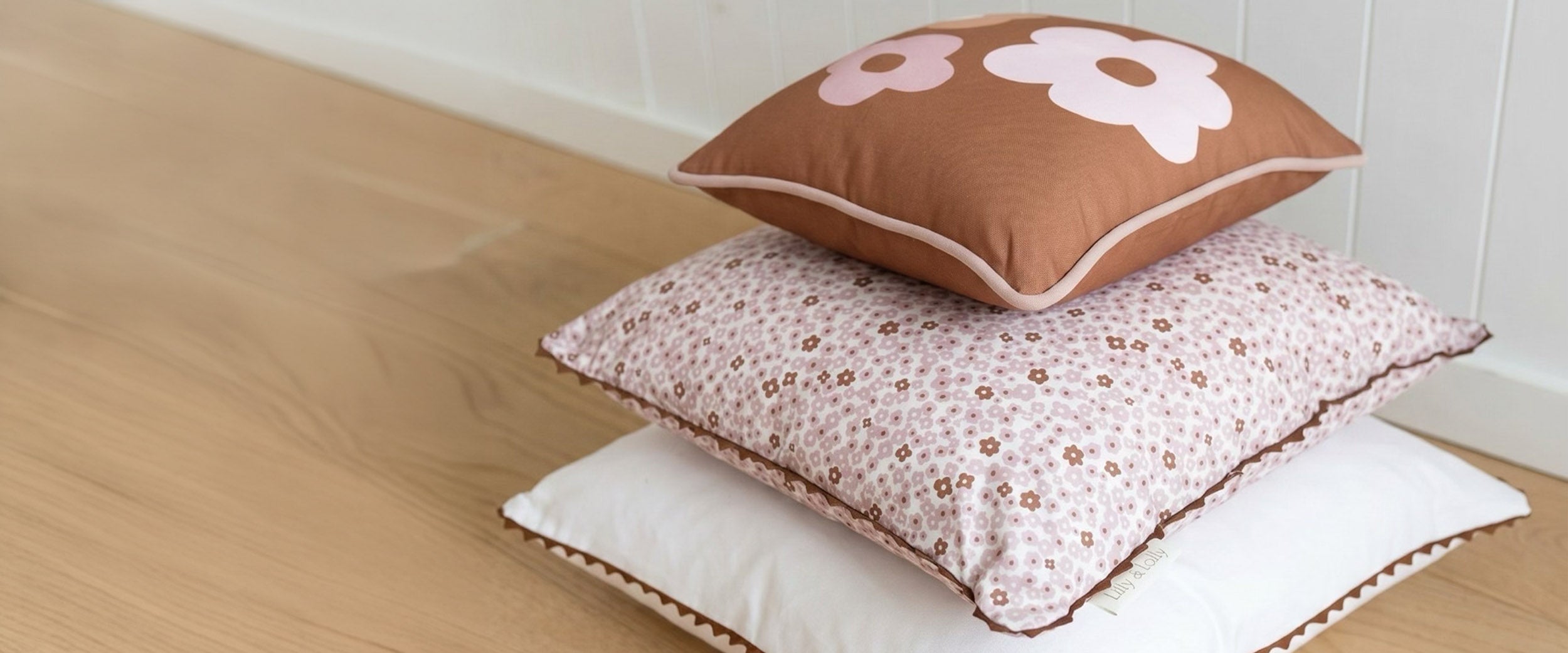 Shop kids bedroom linen and bedding. The Daisy bedding collection features tiny flowers in pink and warm cocoa colours. Collection includes duvet set, pillowcases, cushions, throws and matching daisy ottoman.