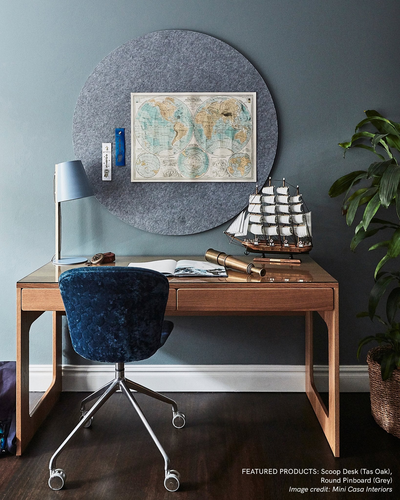 Circular Bulletin board in grey mounted above a desk to help you to achieve a work/life balance.  