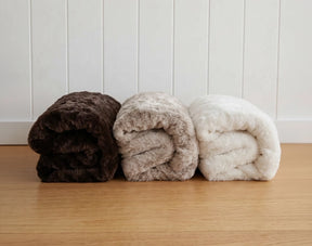 Shop bedding throws and blankets. Image shows the Hare Throw, part of Lilly & Lolly's Daisy Collection which includes sheet set, duvet set, pillowcases, cushions, throws and matching daisy ottoman.