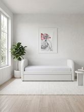 White daybed in a room with a plant and wall art. This bed can be customised with 100s of fabrics to suit your home.