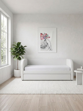 White daybed in a room with a plant and wall art. This bed can be customised with 100s of fabrics to suit your home.