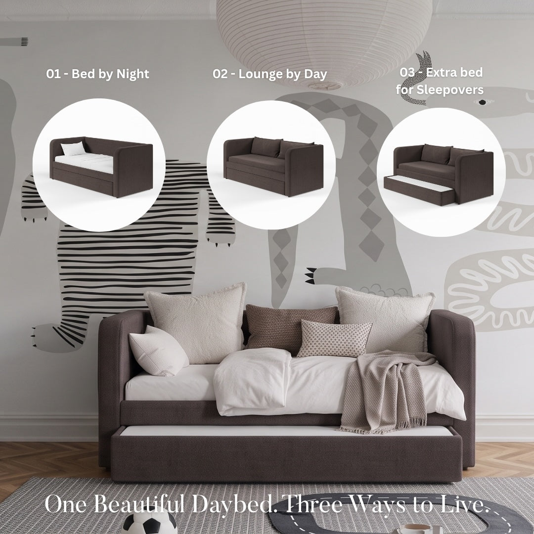 A styled bedroom scene showing a dark brown daybed with white bedding in a modern room, with three circular inset views on the left showing different styling options for the daybed. First is bed by night, the second is lounge by day and the third is showing a trndle bed pulled out as an extra bed for guests. The room has a large animal silhouette mural on the wall, and a window.
