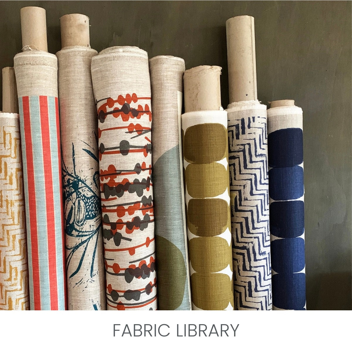 Image features gorgeous rolls of fabric. the text says 'Fabric Library' so you can explore a vast range of fabrics to make your fabric furniture. Fibrary features luxurious velvets, fun prints, bold stripes, heavy textures and tactile plush furs.