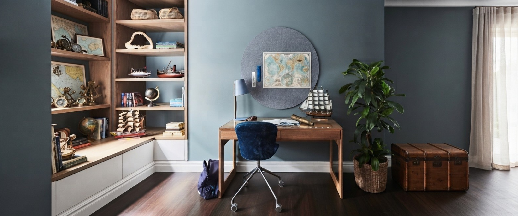 Luxury children's study featuring a handcrafted round architectural felt pinboard, solid timber desk and built-in shelving. Desk is designed and made in Australia.