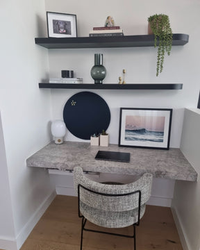 Round felt pinboard mounted above a grey marble desk and styled to perfection for a perfected home office set up.