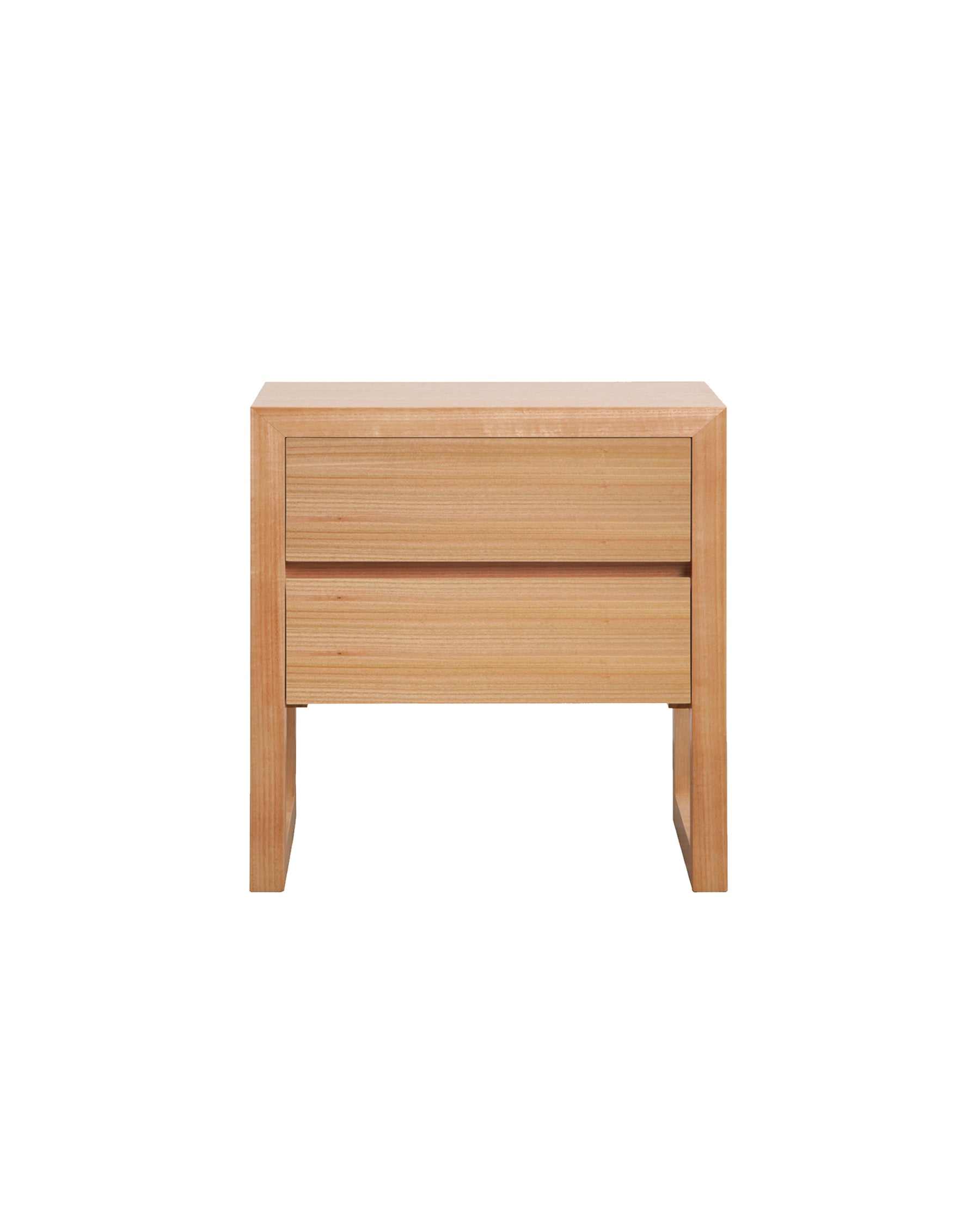 The Oak Box Bedside features a timber frame which encases itself around two timber drawers, concealing intricate mitred joinery with legs that flow into a continuous wrap to create classic simplicity.